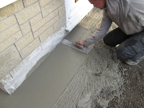 Fresh concrete being worked into position