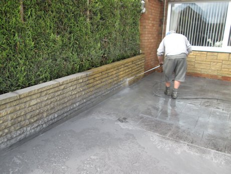 Concrete surface being power washed